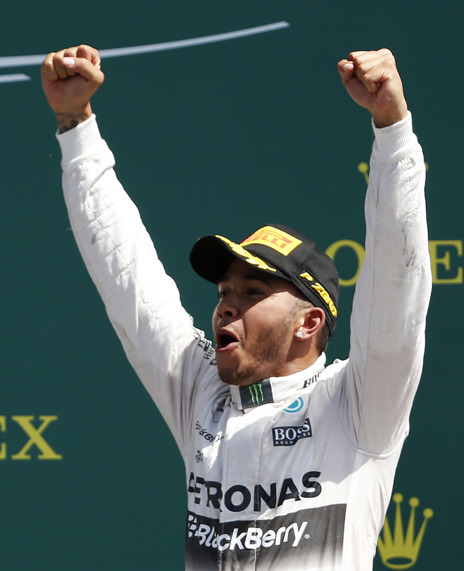 Formula One - F1 - British Grand Prix 2015 - Silverstone, England - 5/7/15 Mercedes' Lewis Hamilton celebrates his win on the podium Reuters / Phil Noble