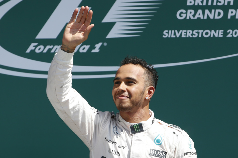 Formula One - F1 - British Grand Prix 2015 - Silverstone, England - 5/7/15 Mercedes' Lewis Hamilton celebrates his win on the podium Reuters / Phil Noble