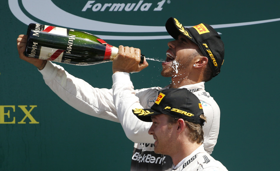 Formula One - F1 - British Grand Prix 2015 - Silverstone, England - 5/7/15 Mercedes' Lewis Hamilton celebrates his win on the podium with the champagne Reuters / Phil Noble